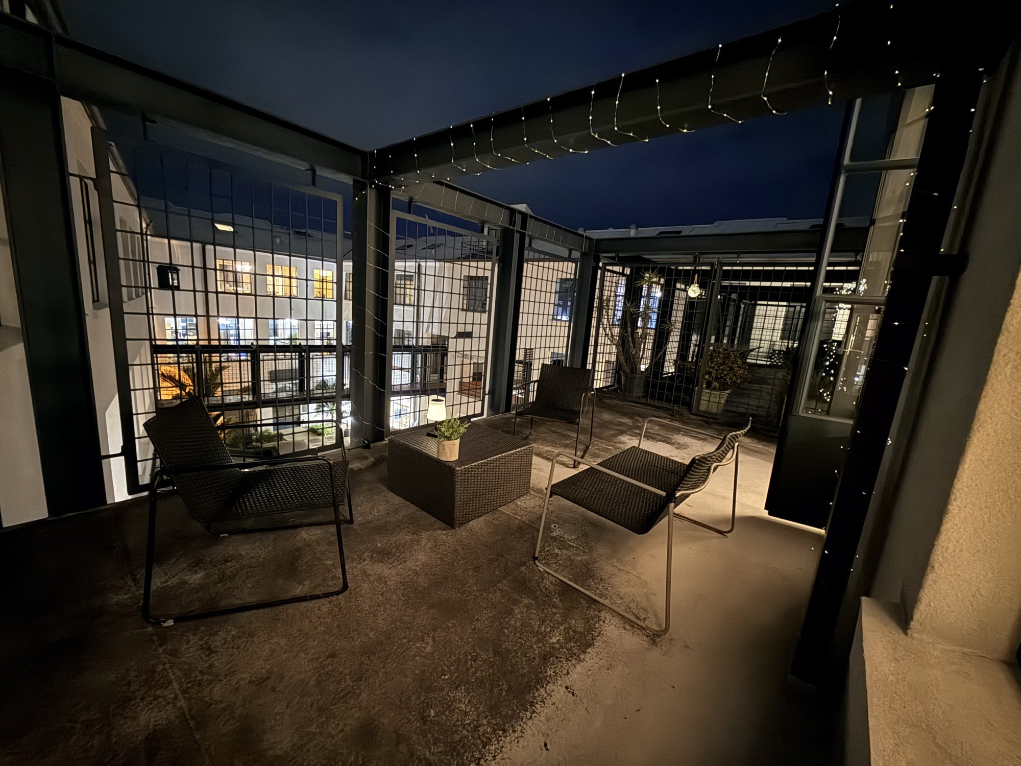 The private terrace at dusk with string lights