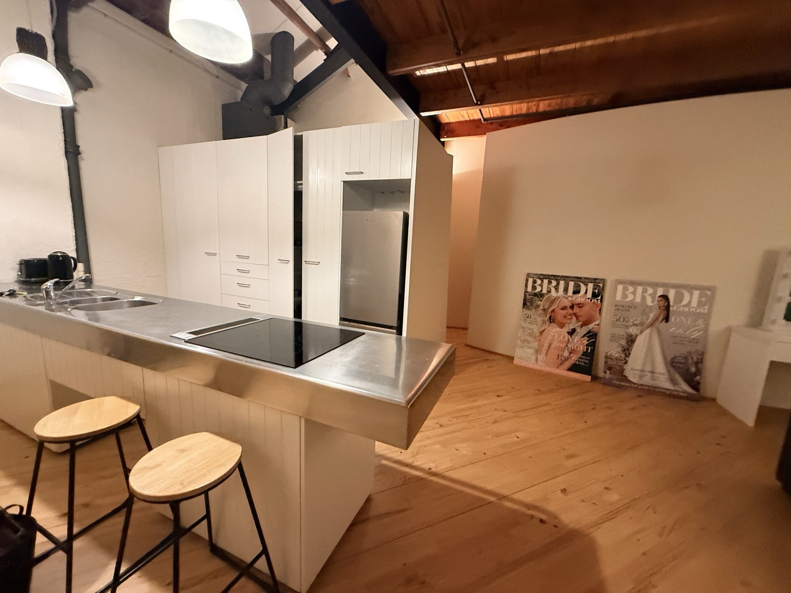 The loft kitchen with stainless counter and breakfast stools