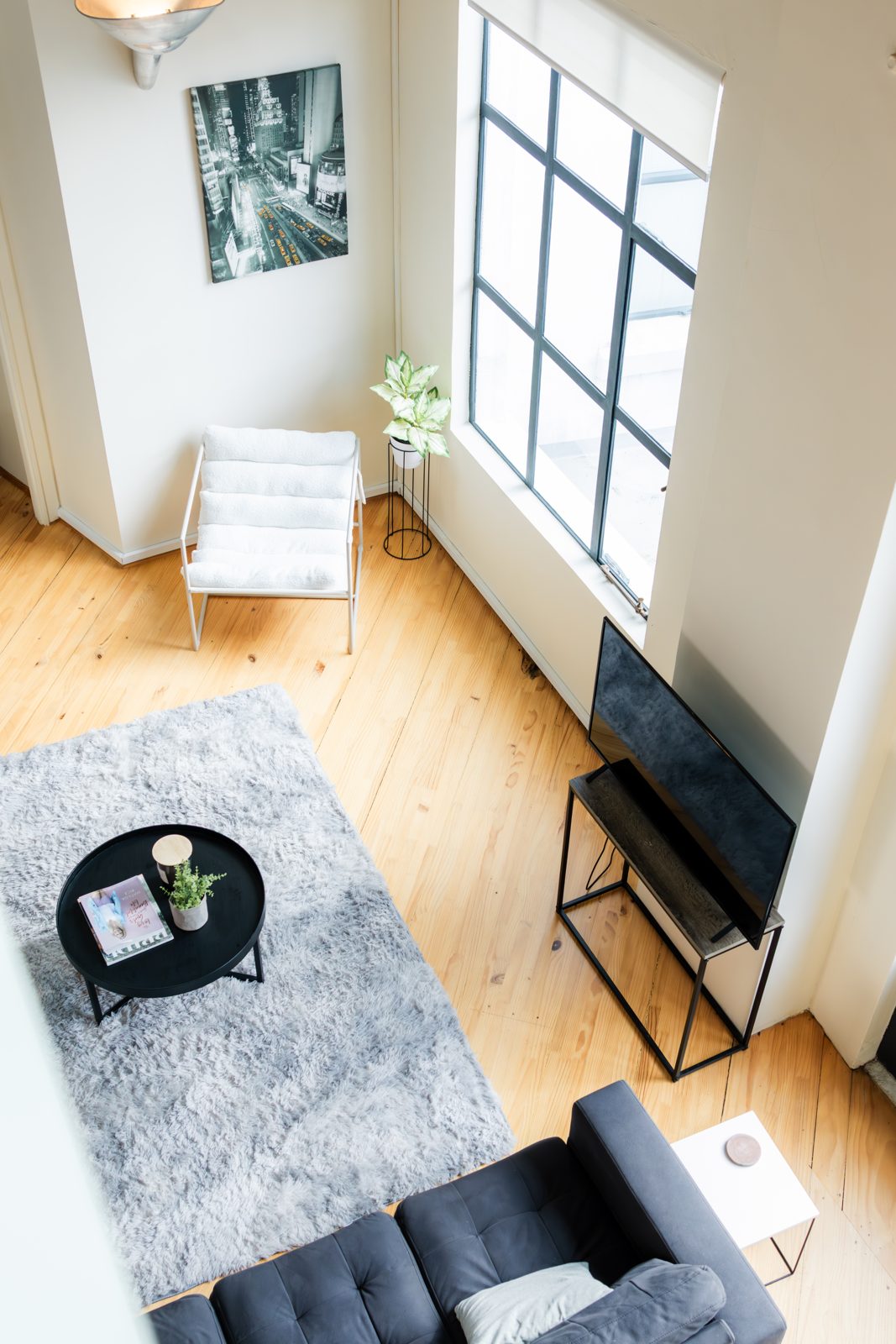 The living area seen from the mezzanine, showing the double-height space